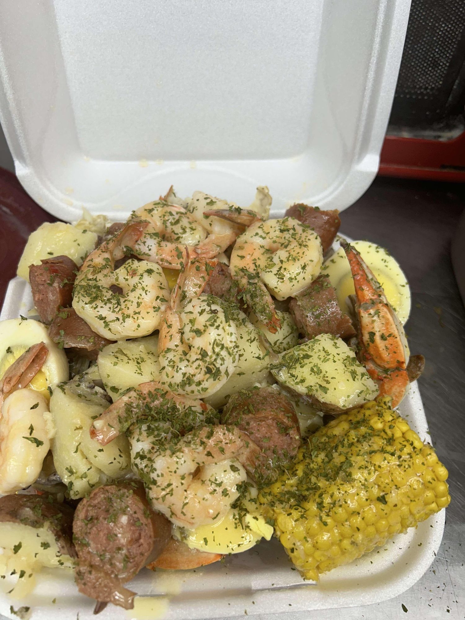 Seafood boil box with sausage and corn